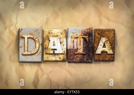 The word "DATA" written in rusty metal letterpress type on a crumbled aged paper background. Stock Photo