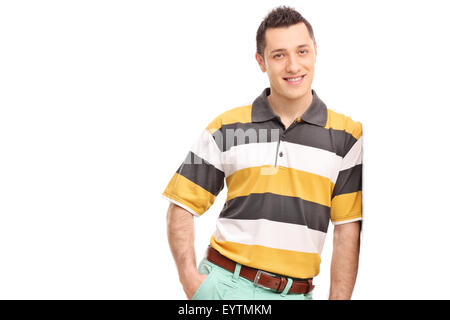 Young casual man leaning against a wall and looking at the camera isolated on white background Stock Photo