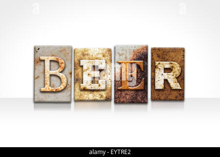 The word 'BEER' written in rusty metal letterpress type isolated on a white background. Stock Photo