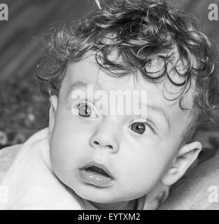 Portrait of a 7 months old baby boy at home with his toys. Stock Photo