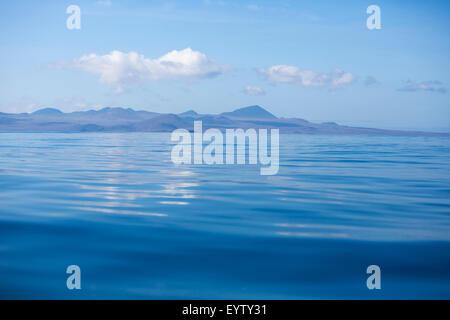 Rock formation in the middle of the Pacific Ocean in the Galapagos Islands against a clear blue sky. Ecuador 2015. Stock Photo