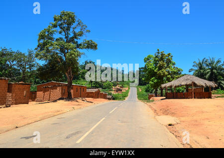 Old tar road crossing villages in rural Angola (Cuanza Norte) Stock Photo