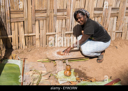Woman preparing Kocho (unleavened bread) made from the False Banana Tree, Dorze, Ethiopia Stock Photo