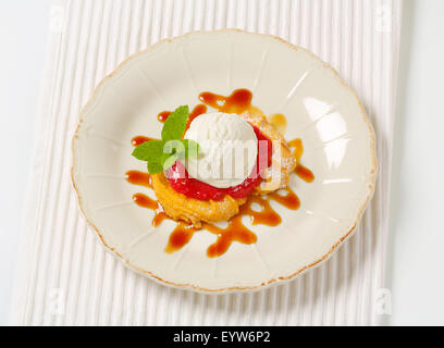 Spritz cookies with raspberry sauce and ice cream Stock Photo