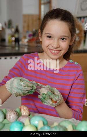 Girl colouring Easter eggs for the Easter basket, coloured eggs, Easter, Upper Bavaria, Bavaria, Germany Stock Photo