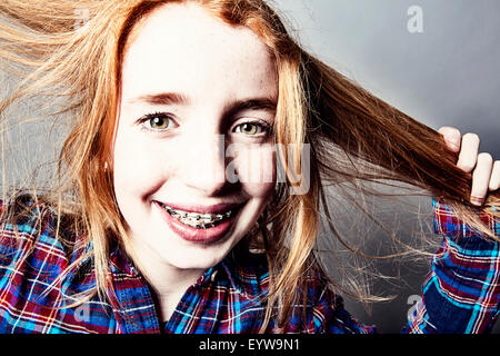 Girl, red-head, with braces and long hair Stock Photo