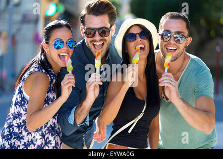 Outdoor portrait of group of friends eating ice cream. Stock Photo