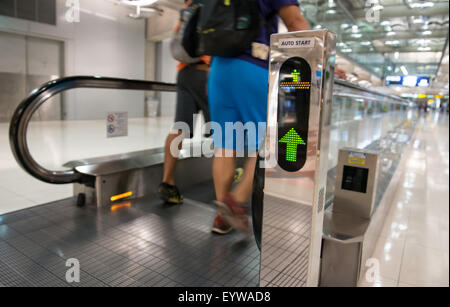 airport escalator with unrecognizable people walking on Stock Photo