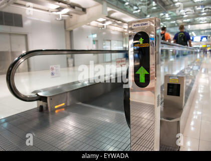 airport escalator with unrecognizable people walking on Stock Photo