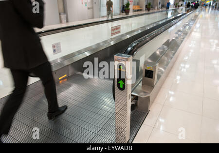 airport escalator with unrecognizable people walking on Stock Photo