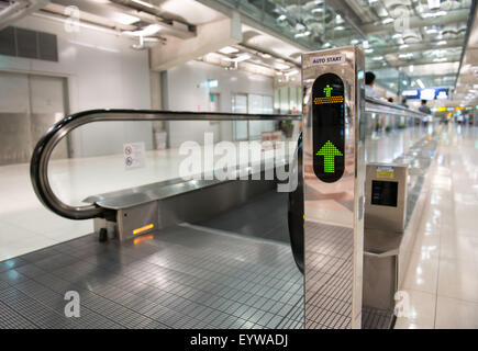 airport escalator with unrecognizable people walking on Stock Photo