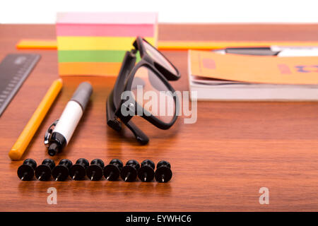 Office desk with glasses pen pencil ruler and other office items Stock Photo