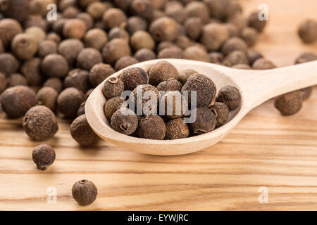 allspice in a wooden spoon on the wood table Stock Photo