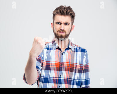 Serious man showing fist at camera isolated on a white background Stock Photo