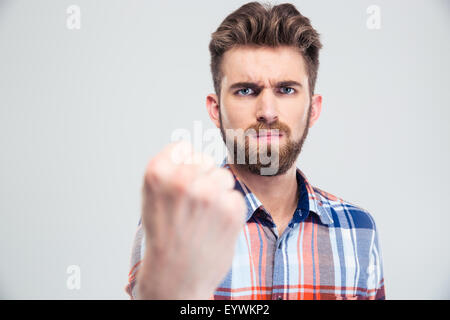 Handsome man showing fist at camera isolated on a white background Stock Photo