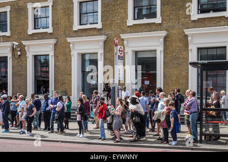 People waiting for a bus in Southwalk, London. Stock Photo