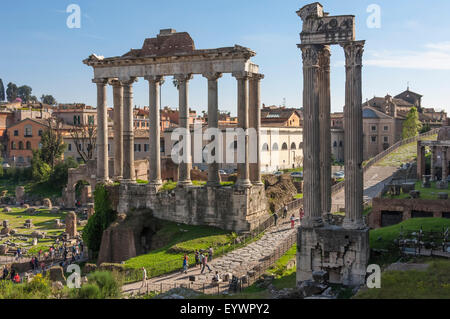 Ancient Roman Road traverses the columns and ruins in the Forum of Ancient Rome, UNESCO World Heritage Site, Rome, Lazio, Italy Stock Photo