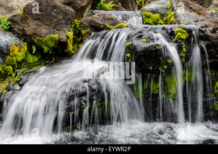 Small stream cascading over rocks in mountains of Kilauea, Kauai, Hawaii, United States of America, Pacific Stock Photo