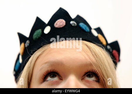 London, UK. 3rd August, 2015. Christie's Head of Sale Kate Summers poses with a felt crown, designed by miliner Stephen Jones originally worn by model Kate Moss on her first magazine shoot in 1989, at Christie's Auction House in London, UK Monday 3, August 2015. The piece is expected to for £5000 when it comes to auction, as part of the Out of the Ordinary Sale on September 10. Credit:  Luke MacGregor/Alamy Live News Stock Photo