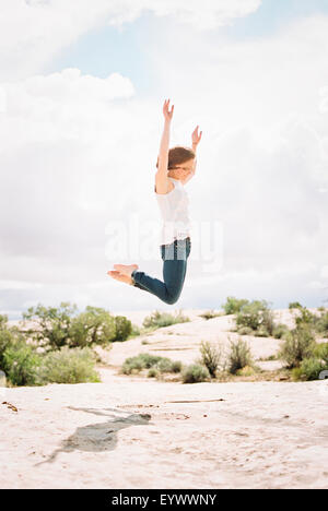 Barefoot woman jumping up in the air Stock Photo