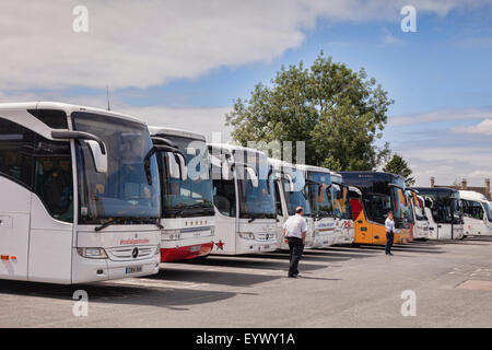 Tour coaches lined up in the Cotswold village of Bourton-on-the-Water, Gloucestershire, England Stock Photo