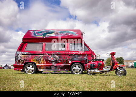 Custom fantasy dragon painted designs on a VW Campervan and scooter at a Transport show. England Stock Photo