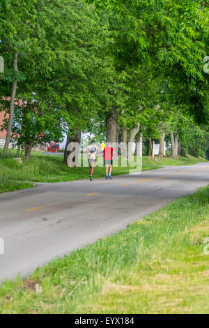 Men running on a rural road  for exercise Stock Photo