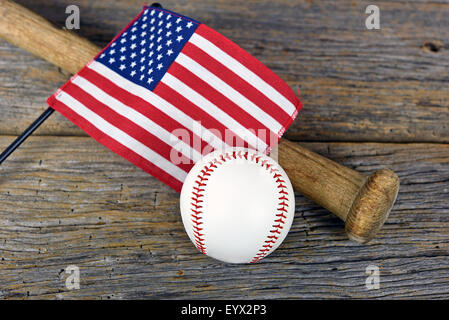 American flag on old wooden baseball bat with white baseball on rustic barn wood. Stock Photo