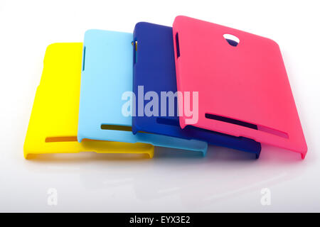 Four bright smartphone back covers on a white background Stock Photo