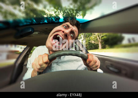 Silly man gets into car crash and makes ridiculous face Stock Photo