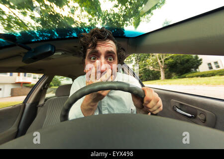 Silly man gets into car crash and makes ridiculous face Stock Photo