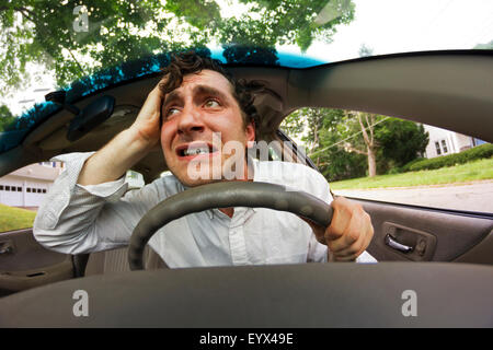 Silly man gets into car crash and makes ridiculous face Stock Photo