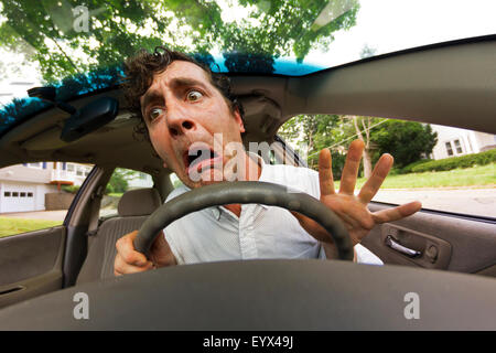 Silly man gets into car crash and makes ridiculous face Stock Photo