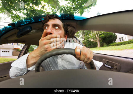 Silly man gets into car crash and makes ridiculous face Stock Photo