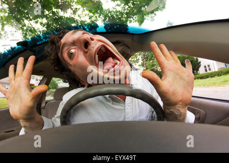 Silly man gets into car crash and makes ridiculous face Stock Photo