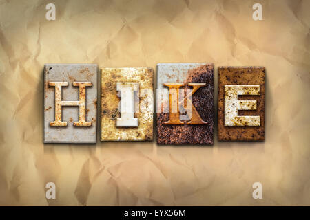 The word "HIKE" written in rusty metal letterpress type sitting on a