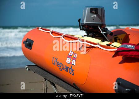 Surf lifesaving, warning flags and equipment on beach ready for use by RNLI lifeguards Stock Photo