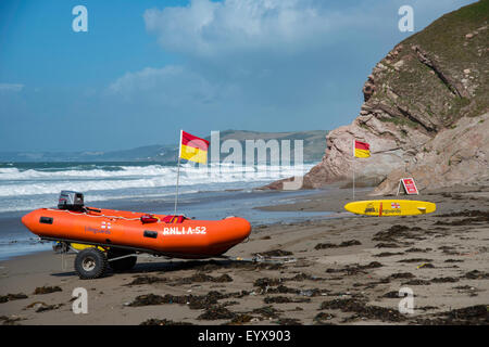 Surf lifesaving, warning flags and equipment on beach ready for use by RNLI lifeguards Stock Photo