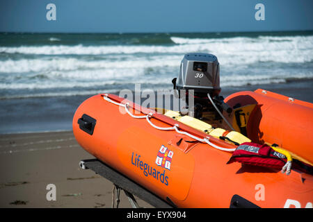 Surf lifesaving, warning flags and equipment on beach ready for use by RNLI lifeguards Stock Photo