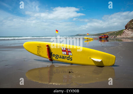 Surf lifesaving, warning flags and equipment on beach ready for use by RNLI lifeguards Stock Photo