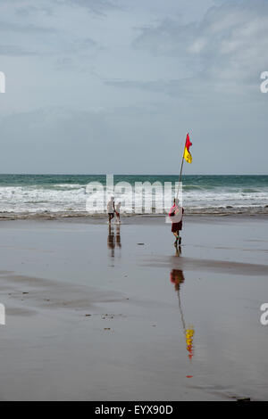 Surf lifesaving, warning flags and equipment on beach ready for use by RNLI lifeguards Stock Photo