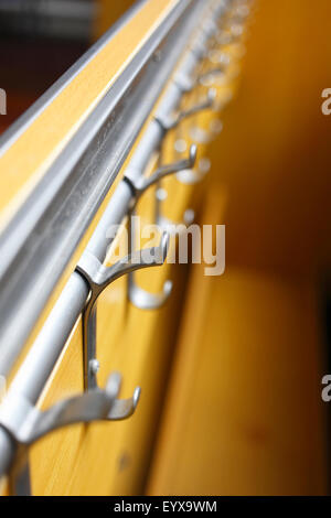 Coat hooks in a school cloakroom. Stock Photo