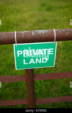'PRIVATE LAND' sign on a farm gate. Stock Photo