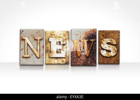 The word 'NEWS' written in rusty metal letterpress type isolated on a white background. Stock Photo