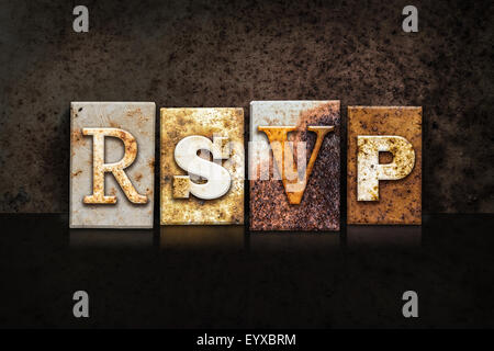 The word "RSVP" written in rusty metal letterpress type on a dark textured grunge background. Stock Photo