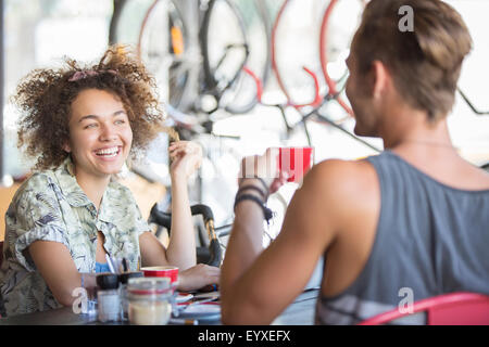 Couple drinking coffee and talking in cafe Stock Photo
