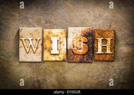 The word 'WISH' written in rusty metal letterpress type on an old aged leather background. Stock Photo