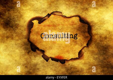 Consulting text on paper hole Stock Photo