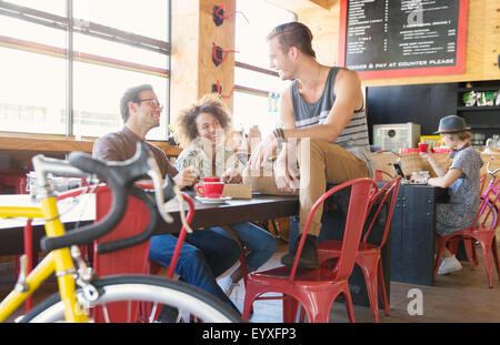 Friends hanging out talking in cafe Stock Photo