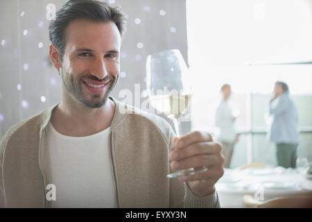 Portrait smiling man drinking white wine in restaurant Stock Photo